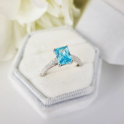 925 Sterling Silver Blue Emerald Cut Cz with Round Cz Shoulders Ring