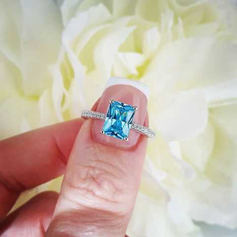 925 Sterling Silver Blue Emerald Cut Cz with Round Cz Shoulders Ring